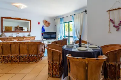 a dining room with a table and chairs at Sunny 2BDR House W/ Private Pool by LovelyStay in Albufeira