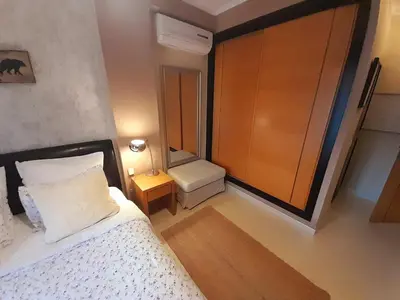 a bedroom with a bed and a chair and a table at Mshomes II in Albufeira