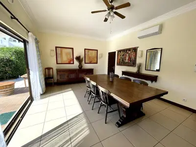 a dining room with a wooden table and chairs at Villa OceanKokia in Albufeira