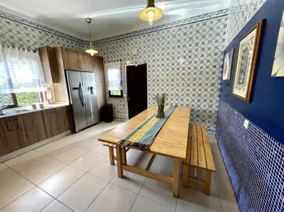 a kitchen with a wooden table in a room at Villa OceanKokia in Albufeira