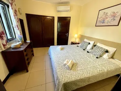a bedroom with a bed and a dresser in it at Villa OceanKokia in Albufeira