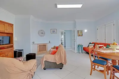 a living room with a couch and a table at Vilamoura Main Avenue by Homing in Vilamoura