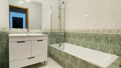 a bathroom with a sink and a bath tub and a mirror at Bicos 101 by Check-in Portugal in Albufeira