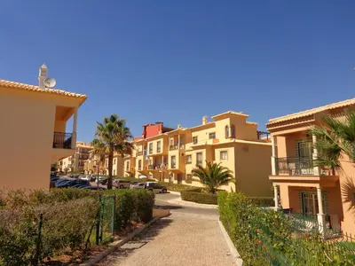 a row of houses on a street with palm trees at Bicos 101 by Check-in Portugal in Albufeira