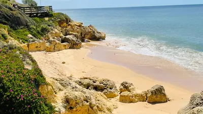 a sandy beach with rocks and the ocean at Bicos 101 by Check-in Portugal in Albufeira