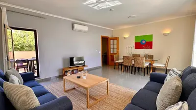 a living room with blue couches and a table at Bicos 303 by Check-in Portugal in Albufeira