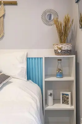 a bedroom with a bed with a blue headboard at Alcharb - Modern Studio - Vilamoura center in Vilamoura