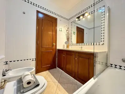 a bathroom with a toilet and a sink and a mirror at Albufeira Salgados Beach 1 by Homing in Albufeira