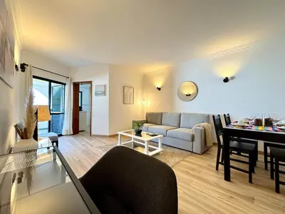 a living room with a couch and a table at Albufeira Salgados Beach 1 by Homing in Albufeira