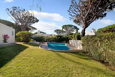 a swimming pool in the yard of a house at Casa Las Trinitarias in Vale do Lobo