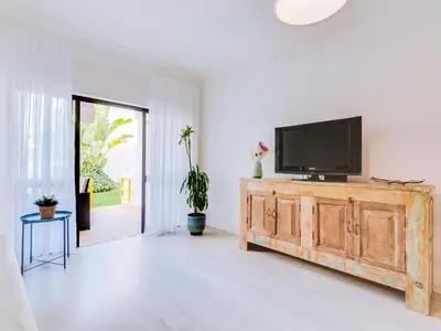 a living room with a flat screen tv on a wooden cabinet at AL - Apartamento Sunrise, Sol Nascente 1 Ground floor in Vilamoura
