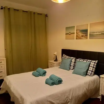 a bedroom with a bed with two towels on it at Sunset View Apartment - 22 in Albufeira