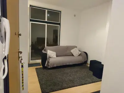 a living room with a couch and a window at Faro City Center Apartment I in Faro