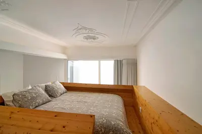 a bedroom with a bed and a window at Casa Vermelha I in Faro