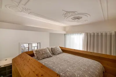 a bedroom with a wooden bed and a window at Casa Vermelha I in Faro