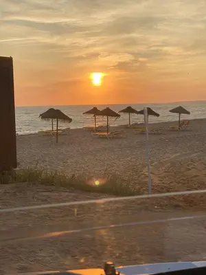 a group of umbrellas on the beach at sunset at Castelo I in Quarteira