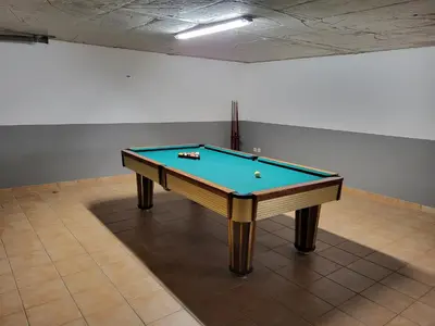 a pool table sitting in an empty room with at Villa Cordeiro - Heated Pool - Free wi-fi - Air Con in Guia