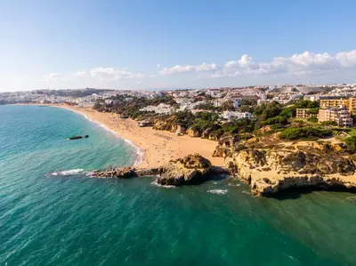 an aerial view of a beach with people in the water at Villa Cordeiro - Heated Pool - Free wi-fi - Air Con in Guia