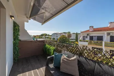 a balcony with two chairs and a fence at Vilamoura Premium Apartment With Pool by Homing in Vilamoura