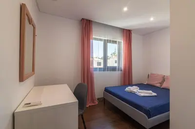 a small bedroom with a bed and a window at Vilamoura Premium Apartment With Pool by Homing in Vilamoura