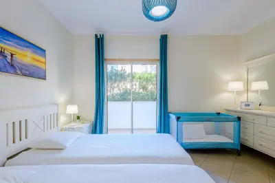 a bathroom with a sink and a tub and a mirror at BnB Homes Ocean view Apartment with huge sunny Terrace, 2 Swimming pools & Tennis court in Albufeira