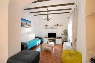 a dining room with a white table and chairs at Vila Caracol in Guia
