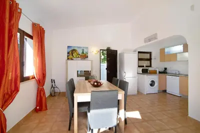 a kitchen and dining room with a table and chairs at Vila Filipa in Guia