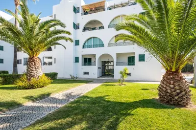 a small bathroom with a washer and dryer in it at #068 T1 Salgados by Home Holidays in Guia