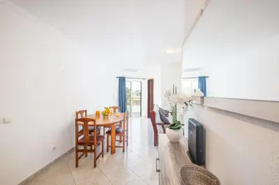 a kitchen with white cabinets and a stove top oven at #068 T1 Salgados by Home Holidays in Guia