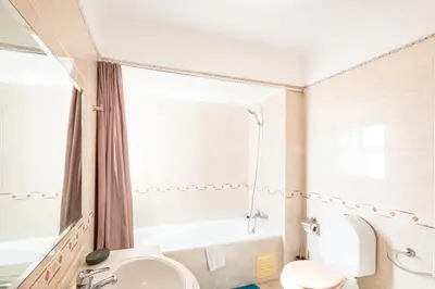 a bathroom with a sink and a mirror and a tub at #068 T1 Salgados by Home Holidays in Guia