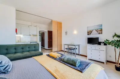 a bedroom with a bed and a desk in a room at Apartment Vista Mar Piscina Albufeira in Albufeira