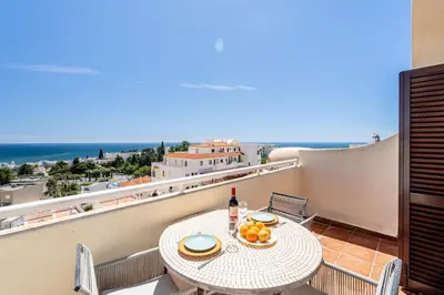 a hotel with a swimming pool in front of a building at Apartment Vista Mar Piscina Albufeira in Albufeira
