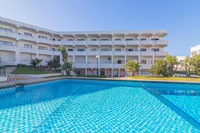 a large swimming pool in front of a hotel at Vilamoura Cosy 2 with Pool by Homing in Vilamoura