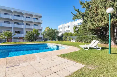 a swimming pool in front of a building at Vilamoura Cosy 2 with Pool by Homing in Vilamoura