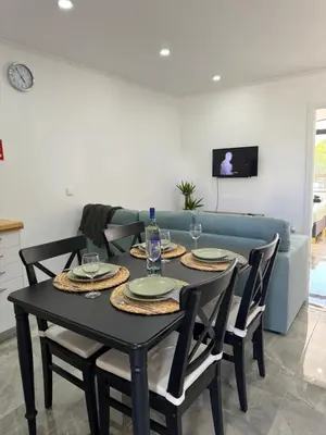 a dining room with a black table and chairs at The Strip Oura apartment in Albufeira