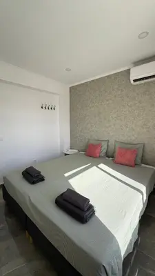 a bedroom with a large bed with red pillows on it at The Strip Oura apartment in Albufeira