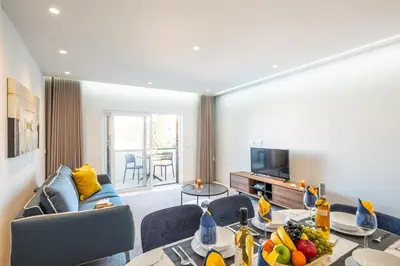 a living room with a couch and a table at Apartment Melbourne 1 by Algarve Vacation in Albufeira