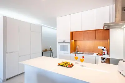 a kitchen with white cabinets and a white counter top at Apartment Melbourne 1 by Algarve Vacation in Albufeira