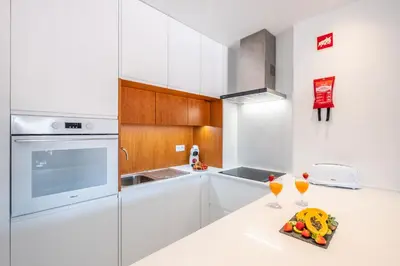 a kitchen with white cabinets and a white counter top at Apartment Melbourne 1 by Algarve Vacation in Albufeira