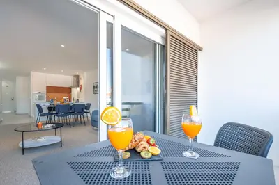 a table with two glasses of orange juice on it at Apartment Melbourne 1 by Algarve Vacation in Albufeira