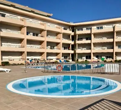 a swimming pool in front of a large apartment building at Albufeira - Apartment - Sleeps 4 - Pool - Seaside in Albufeira