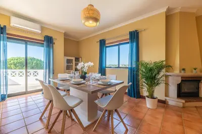 a dining room with a table and chairs at #071 Maria Luisa by Home Holidays in Albufeira
