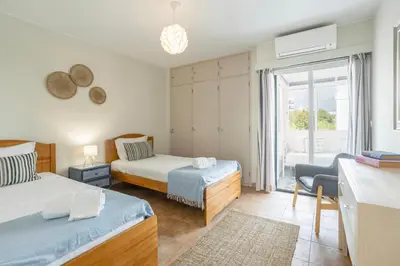 a bedroom with two beds and a balcony at Centralgarve - Amazing Apt in the Heart of Vilamoura in Vilamoura