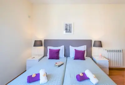 a bedroom with a large bed with purple pillows at Villa Poseidon by Algarve Vacation in Albufeira