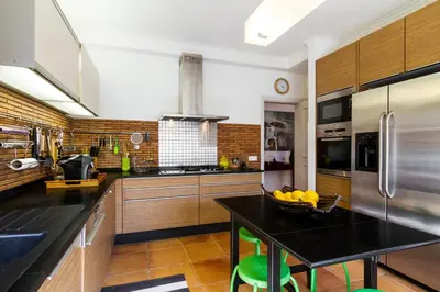 a kitchen with a table with a bowl of bananas on it at Varandas Do Lago Villa in Almancil