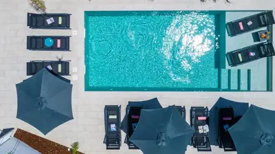 an overhead view of a swimming pool with blue umbrellas at Villa Paradisius by Algarve Vacation in Albufeira