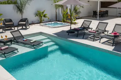 a swimming pool with lounge chairs and a swimming pool at Villa Paradisius by Algarve Vacation in Albufeira