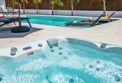 a swimming pool with a tub in the middle at Villa Paradisius by Algarve Vacation in Albufeira