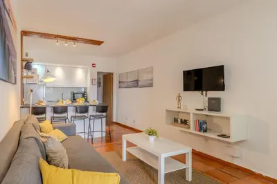 a bedroom with a bed with a surfboard on it at #065 Zulmira Flat by Home Holidays in Albufeira