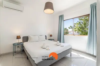 a bedroom with a bed and a large window at #072 Casa Longa by Home Holidays in Albufeira